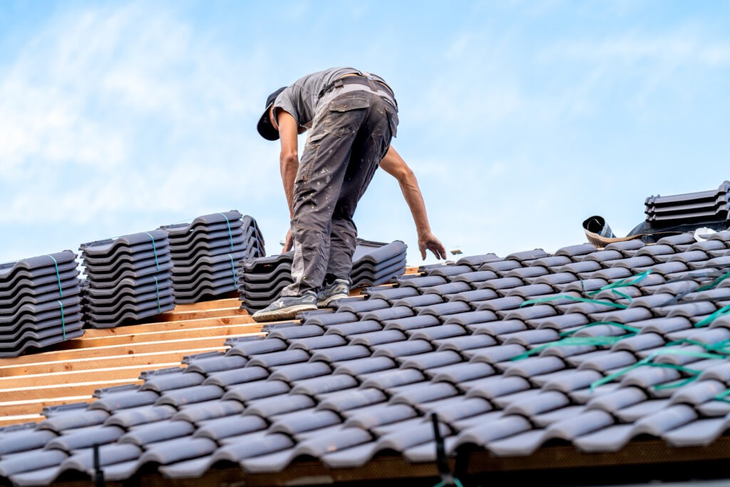 new bungalow roof, craftsman installs ceramic tile roofing.